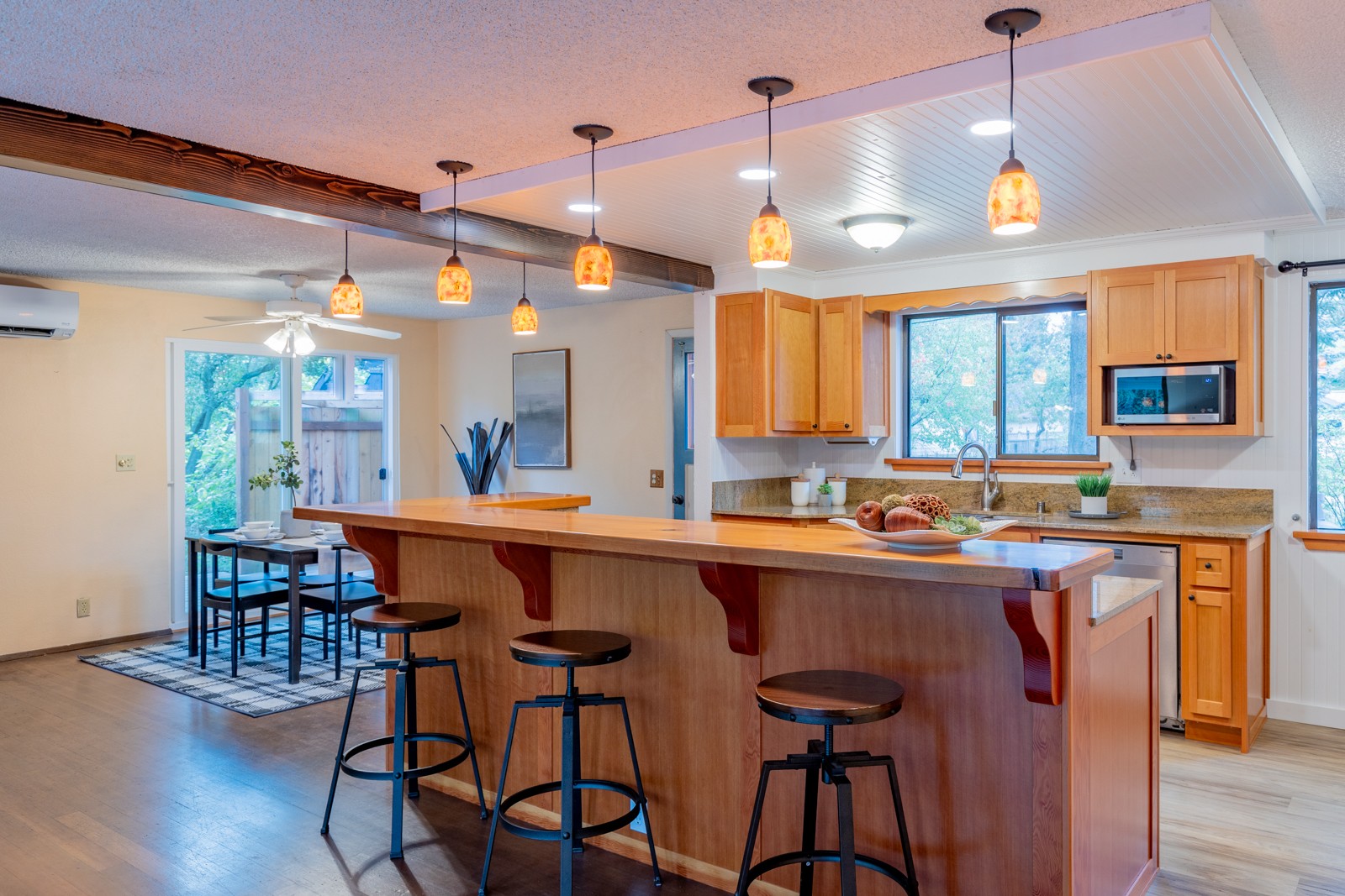 Custom kitchen island with granite counter and bar seating
